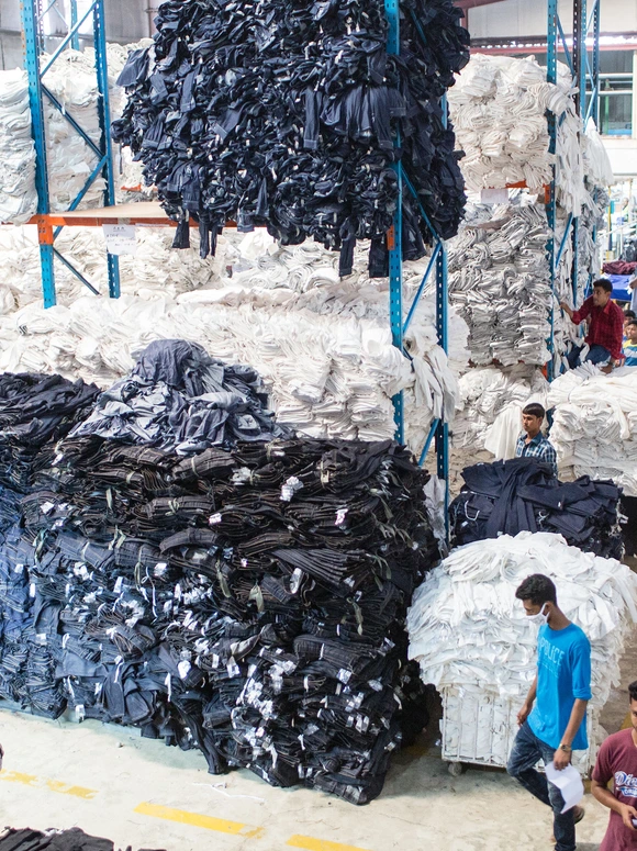 Sorted black and white textile leftovers inside a warehouse