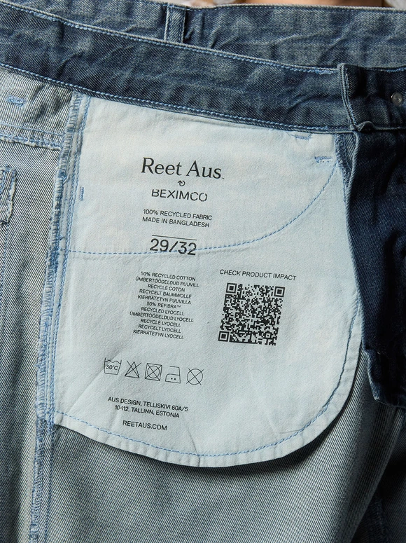 Denim garment label with environmental impact information and a QR code