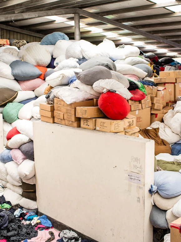 Textile materials stored in large sacks inside a production facility